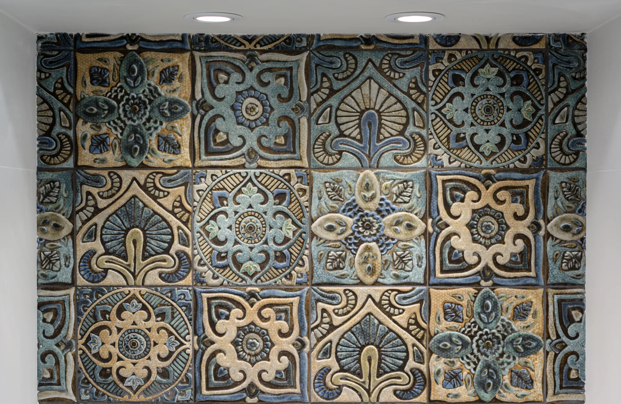 Panel of ornamental ceramic tiles in blue and sand tones