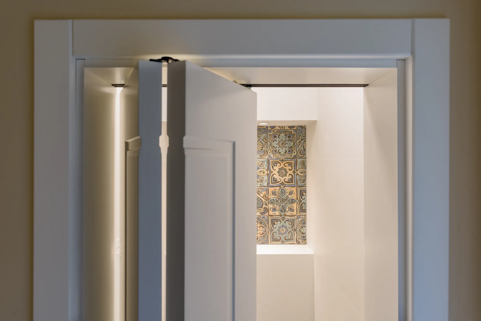 View through the door to the niche with decorative tiles